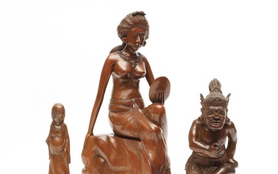 Bali, a sculpture of a seated woman holding a mirror; herewith a standing pregnant woman and a squatting figure with elaborate headdress, mid-20th C.