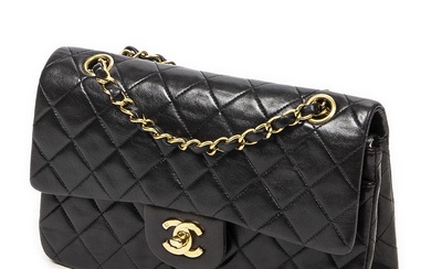 Chanel A “Classic Double Flap” bag of dark brown quilted leather with...