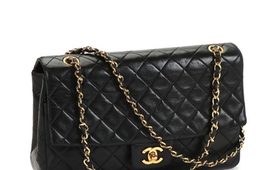Chanel: A “Vintage single flap” bag made of black quilted lamb skin with a golden doublechain handle, one exterior pocket, one compartment with five pockets.