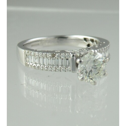 Diamond solitaire ring with baguette diamond shoulders. Rin...
