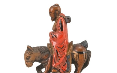 JAPANESE NEGORO LACQUER-ON-WOOD NETSUKE In the form of a scholar riding a horse. Set on a rectangular base. Height 2".