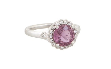 Lady's Platinum Sapphire Dinner Ring, with a 2.34 carat round pink sapphire atop a border of tiny