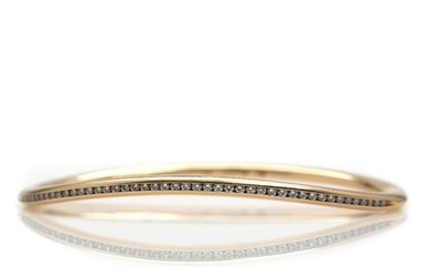 Openable diamond bangle set with numerous brilliant-cut diamonds, mounted in 14k gold....