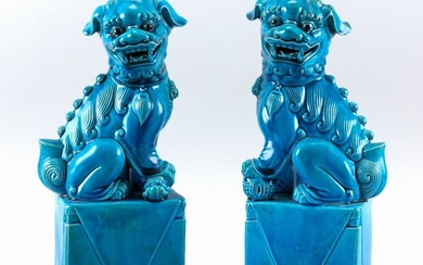 PAIR OF CHINESE TURQUOISE-GLAZED PORCELAIN FOO DOGS On pedestals, with ball and pup underfoot. Heights 12".