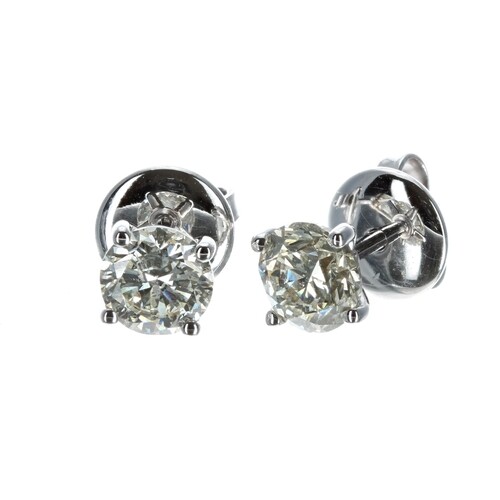Pair of modern 18ct white gold claw-set diamond ear studs, r...