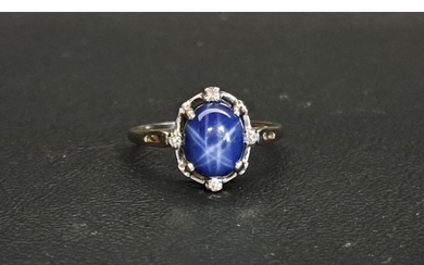 STAR SAPPHIRE AND DIAMOND RING the central cabochon sapphire...