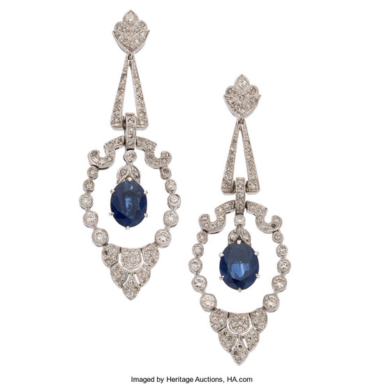 Sapphire, Diamond, White Gold Earrings The earrings feature oval-shaped...
