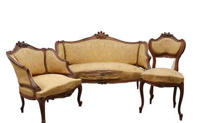 Set of couch "canapé", Bergère” armchair and chair in Rococo style, Modernist period, in carved walnut, early decades of the 20th Century.