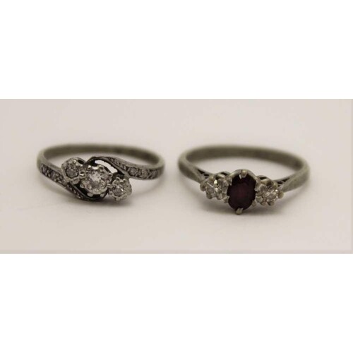 TWO 18CT GOLD LADY'S RINGS, on set three diamonds, one a rub...