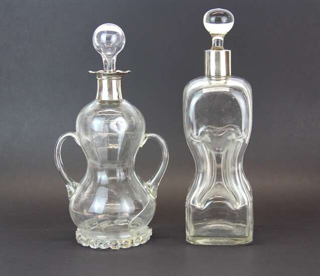 Two interesting Victorian decanters, one with hallmarked silver rim, H. 28cm.