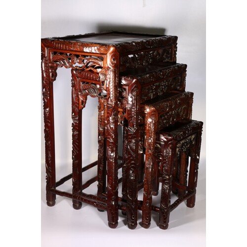 20th century Chinese nest of four hardwood tables, carved ed...