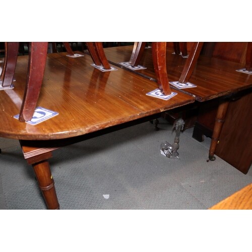 A 19th century mahogany extending dining table with one extr...