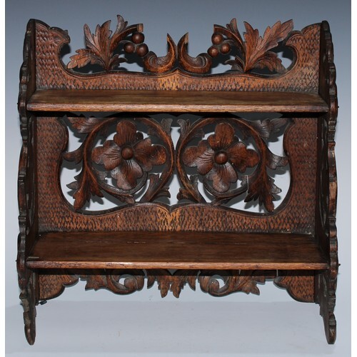 A Black Forest table-top two-shelf bookcase, the hinged side...