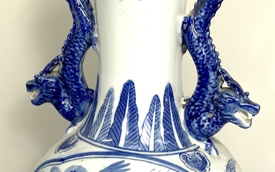 A Chinese blue and white vase and matching base, modern, decorated in underglaze glue with Dragons