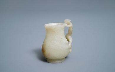 A Chinese celadon russet jade chilong Handled jug,...