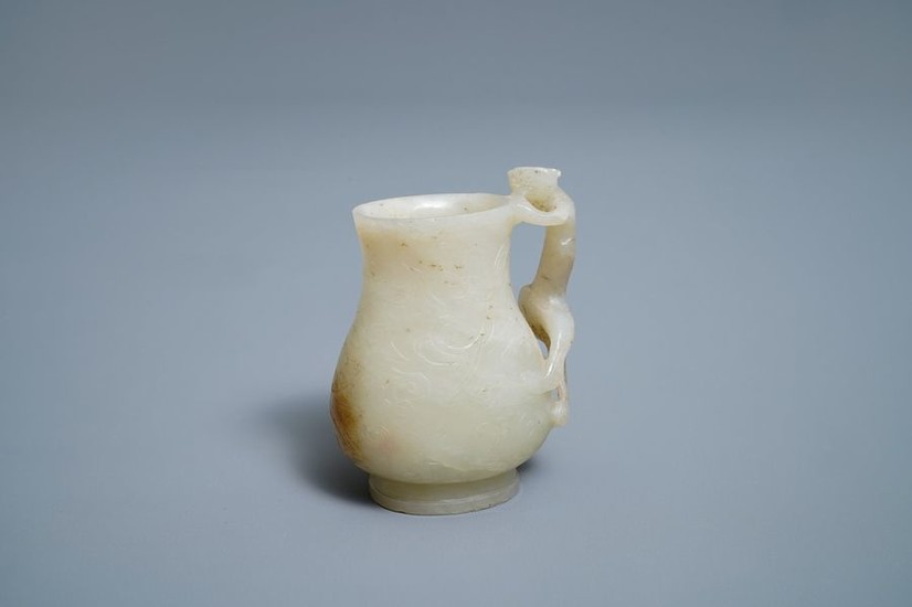 A Chinese celadon russet jade chilong Handled jug,...