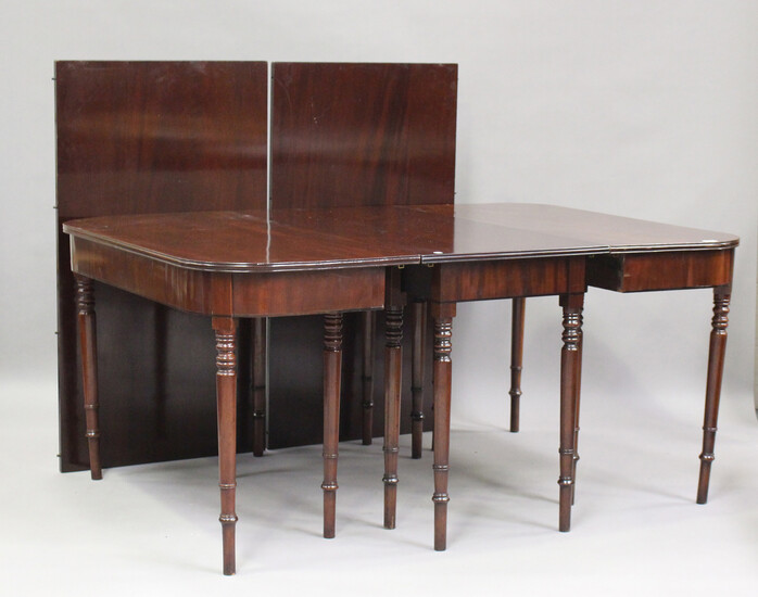 A George III mahogany dining table with central additional section and two extra leaves, on turned l