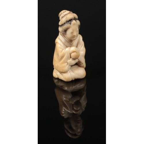 A Japanese Meiji period carved ivory small okimono. Formed a...