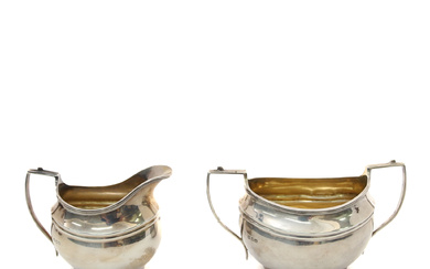 A REGENCY STYLE OVAL SILVER TWO-HANDLED SUGAR BASIN AND MILK JUG.