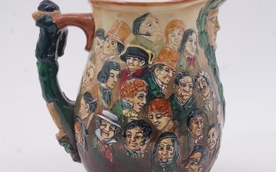 A Royal Doulton 'Dickens Jug', c.1933, designed by Charles Noke, marks to base and Reg no 771321, of large proportions, with mask spout and figural handle, the body with masks of Dickens characters, incised Keep my memory green Noke, 26.5cm high