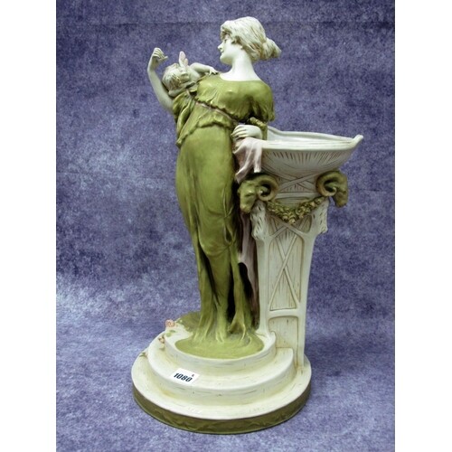 A Royal Dux Pottery Model of a Lady, standing with a cherub ...