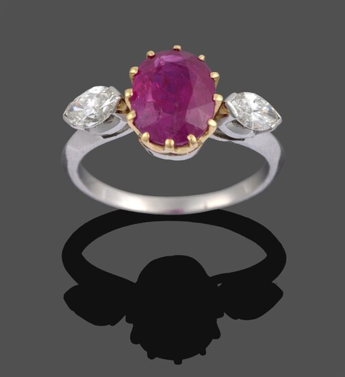 A Ruby and Diamond Three Stone Ring, the oval cut ruby in a yellow claw setting sits between...