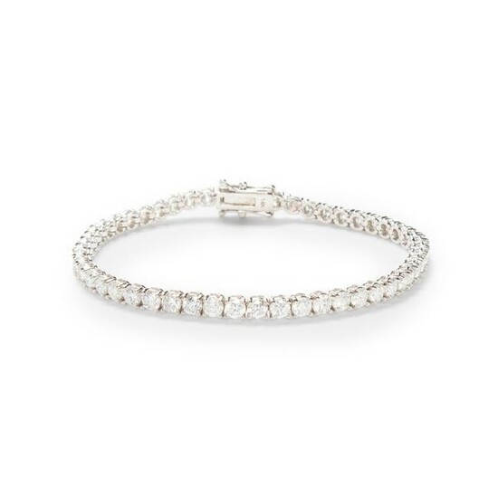 A diamond and fourteen karat white gold bracelet