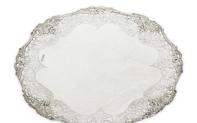 A footed silver dish with foliate pierced sides, Sheffield, 1956, Frank Cobb & Co., designed with cast fruiting vine border and raised on a low circular foot, 28cm wide, 5cm high, approx. weight 21.5oz