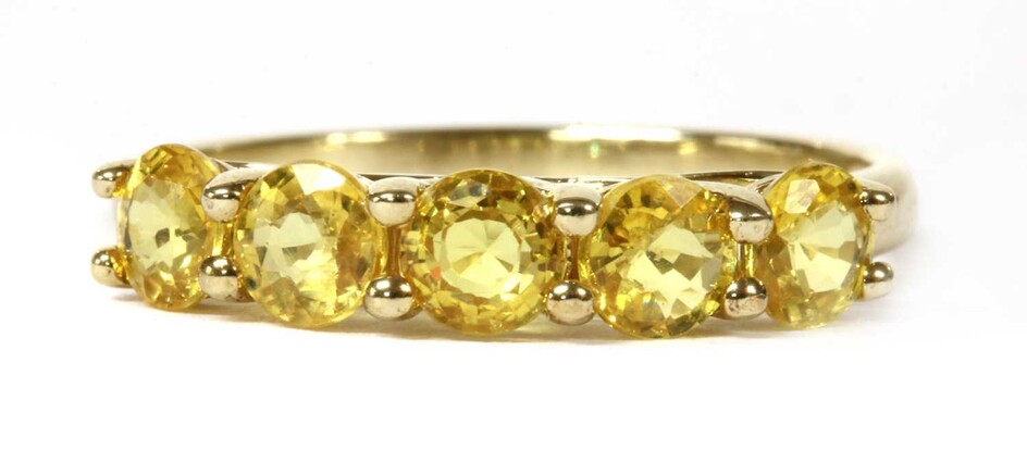 A gold five stone yellow sapphire ring