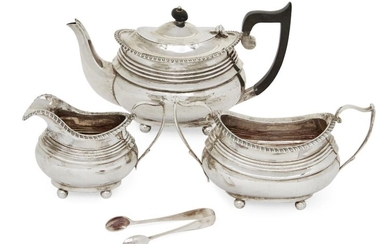 A matched silver three piece tea set by George Nathan & Ridley Hayes, the teapot and sugar Chester c.1914 and 1915, the milk jug Birmingham, c.1916, of rectangular form with gadrooned rims and reeded banding to bodies, together with a pair of sugar...