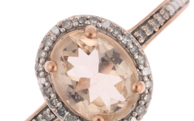 A modern 9ct rose gold smoky quartz and diamond oval cluster...