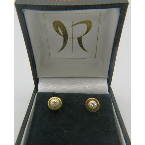 A pair of 14ct yellow gold and diamond stud earrings, marked...