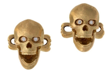 A pair of 18ct gold diamond skull cufflinks, by Ralph Lauren, each modelled as a skull with articulated jaw that when opened brilliant cut diamond eyes appear, to opposing hinged bar each modelled as crossbones, makers mark RL for Ralph Lauren...
