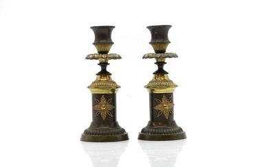 A pair of Regency bronze and ormolu candlesticks