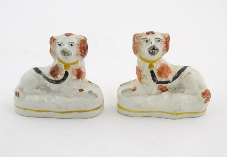 A pair of Victorian Staffordshire pottery seated