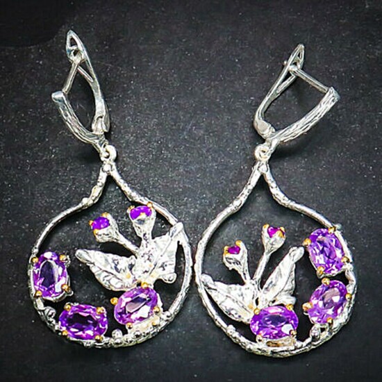 A pair of amethyst ear pendants each et with numerou circular and oval-cut amethyst, mounted in rhodium plated terling silver. L. 4.7 cm. (2)