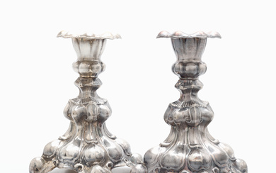 A pair of baroque candlesticks, nickel silver, mid 20th century.