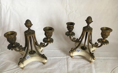 A pair of bronze candleholders with two arms...