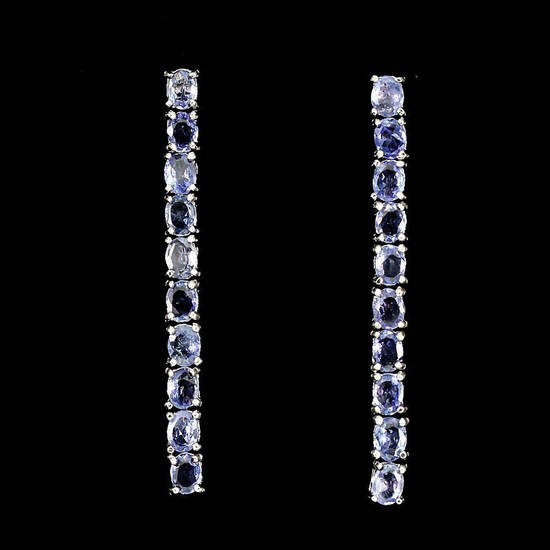 A pair of tanzanite ear pendants each set with numerous oval-cut tanzanites, mounted in rhodium plated sterling silver. L. 4.2 cm. (2)