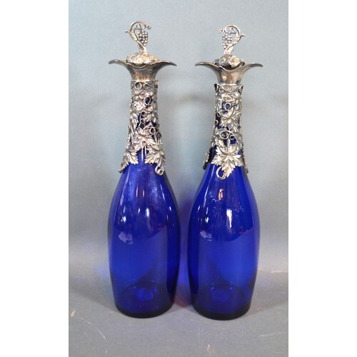 A pair silver plated and blue glass decanters, decorated wit...