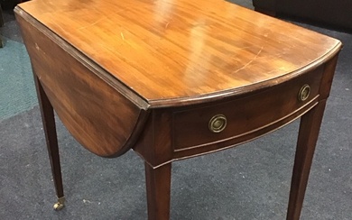 A regency mahogany oval pembroke table with two leaves opening...