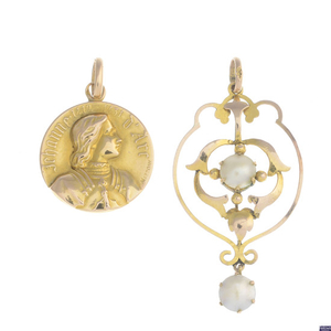 A selection of four early 20th century gold pendants.