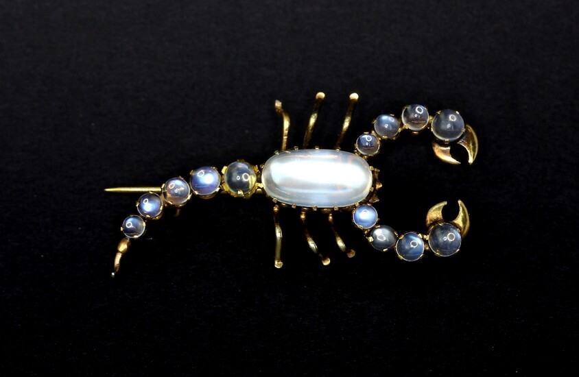 A yellow metal (tested minimum 9ct gold) scorpion shaped brooch set with cabochon cut moonstones, L. 4.2cm.