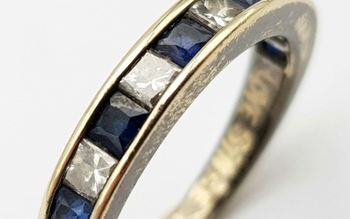 An 18K Gold Diamond and Sapphire Half-Eternity Ring. Size...