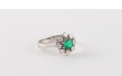 An 18ct white gold emerald & diamond cluster ring, claw set ...
