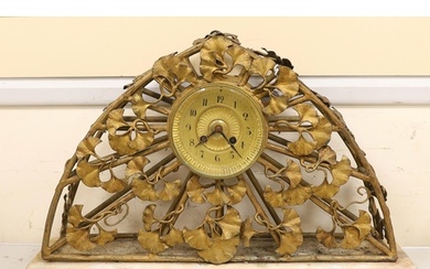 An Art Nouveau gilt metal clock, 51cm wide, 33cm high
