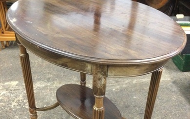 An Edwardian mahogany oval occasional table with moulded top raised...