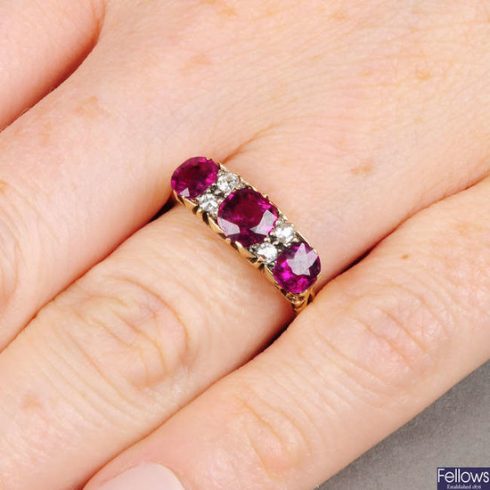 An early 20th century 18ct gold Thai ruby three-stone ring, with old-cut diamond accents.