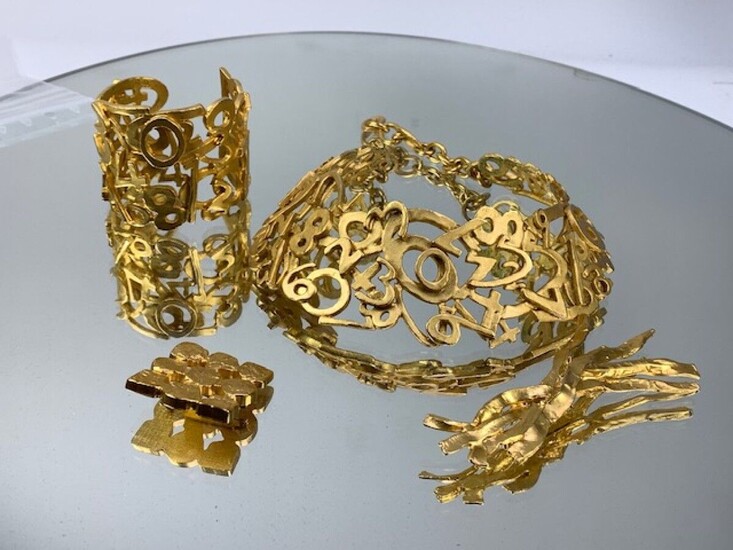 BICHE DE BEERE- Parure en métal doré comprenant collier et bracelet manchette à décor ajouré,...