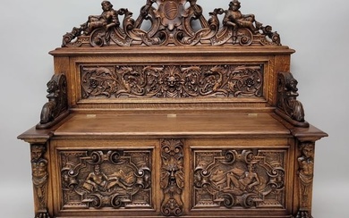 Circa 1880's Heavily Carved Horner Lift Seat Bench with Putti, Griffins, & Northwind Face. All